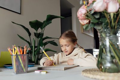 Portrait of cute girl studying at home