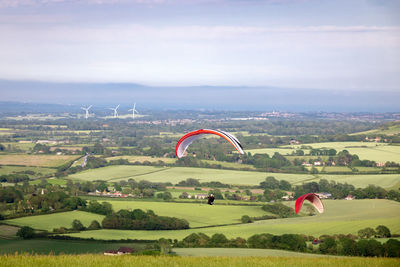 Paragliders over rural landscape