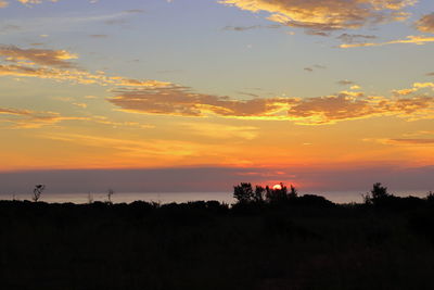Scenic view of silhouette landscape against sky during sunset