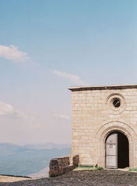 Building by sea against sky