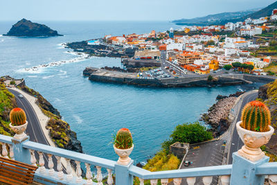 High angle view of buildings by sea against sky