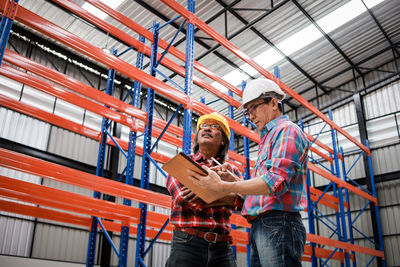 Low angle view of people working at construction site