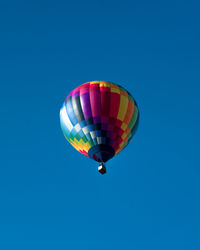 Low angle view of hot air balloon against blue sky