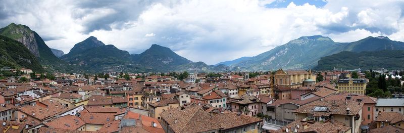 Panoramic view of townscape and mountains against sky