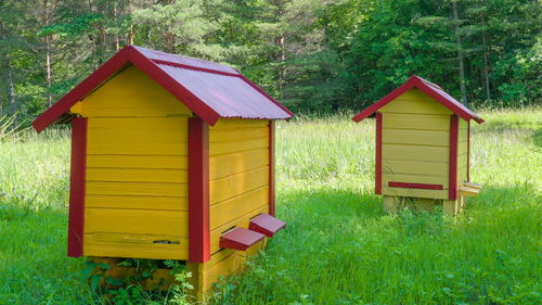 Built structure on field against trees and house