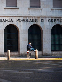 Man riding bicycle on street in city