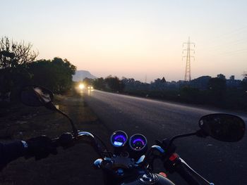 Cars on road at sunset