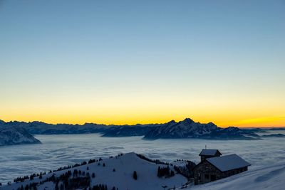 Scenic view of snow covered landscape against clear sky