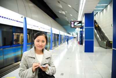 Portrait of woman on railroad station platform