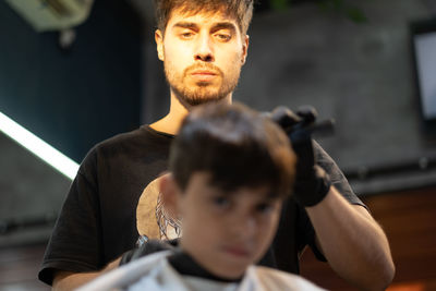 Portrait of hairdresser working