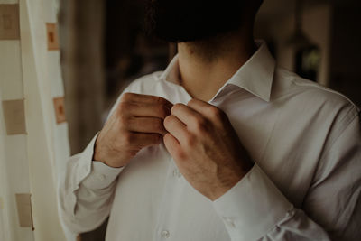 Midsection of man holding camera