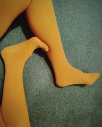 Low section of woman on yellow legs