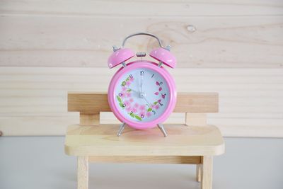 Alarm clock on table against wall