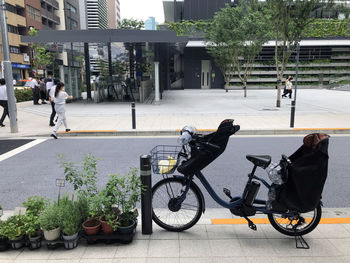 People riding bicycle on street in city