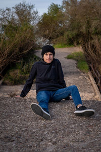 Portrait of smiling man sitting on land