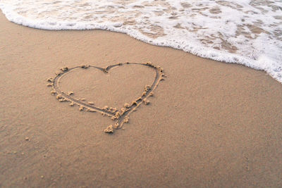 Heart shape on sand at beach