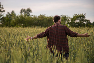 Rear view of man standing on field