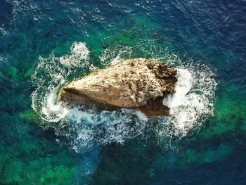 High angle view of rock formation in sea