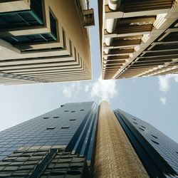 Directly below shot of buildings against sky