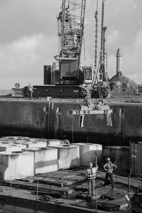 Worker in front of a lifting crane in a port