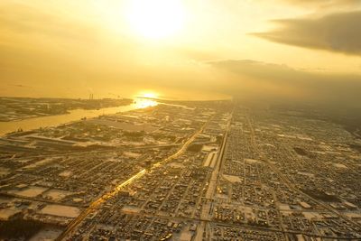 Aerial view of cityscape against sky during sunset