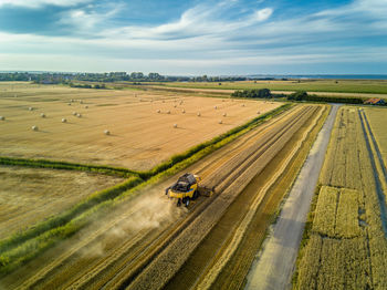 Aerial view of combine harvester harvesting at farm