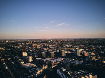 High angle view of city buildings against sky during sunset