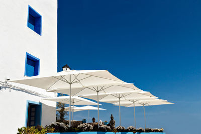 Low angle view of buildings against clear blue sky