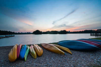 Upside down kayak at lakeshore during sunset