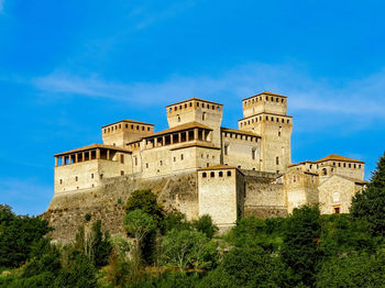 Low angle view of historical building against blue sky