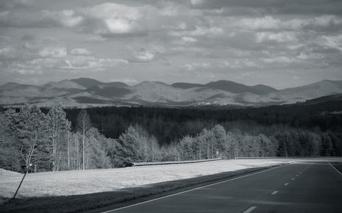 Empty road with mountains in background