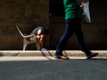 Low section of men standing on street