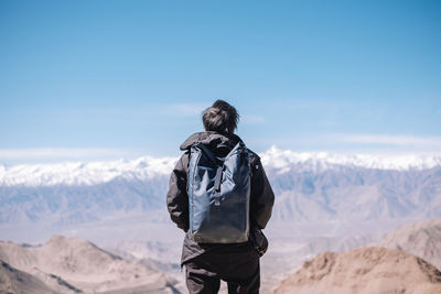 Rear view of man standing on mountain