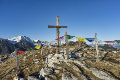 Traditional windmill on mountain against blue sky