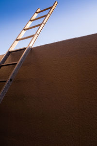 Low angle view of windmill on desert against sky