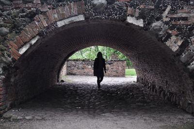 Full length of woman walking in tunnel