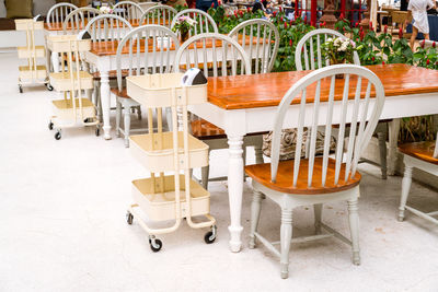 Empty chairs and tables at sidewalk cafe