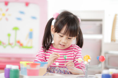 Portrait of cute girl at table