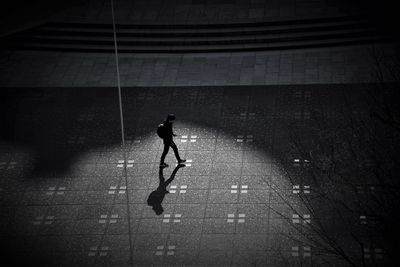 High angle view of man walking at pavement