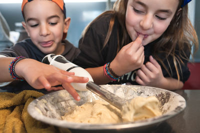 Smiling siblings eating ice cream