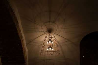 Illuminated lamp against sky at night