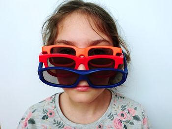 Portrait of girl wearing sunglasses against white background