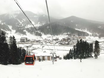 Ski lift over snowcapped mountains during winter