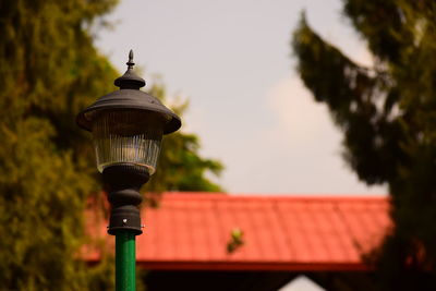 Low angle view of street light against building