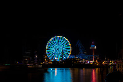 Illuminated ferris wheel at night