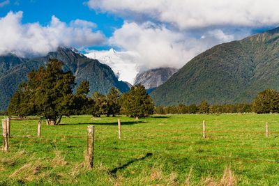 Scenic view of landscape and mountains against sky