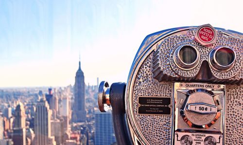 Close-up of coin-operated binoculars against sky