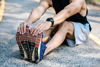 Low section of man stretching outdoors