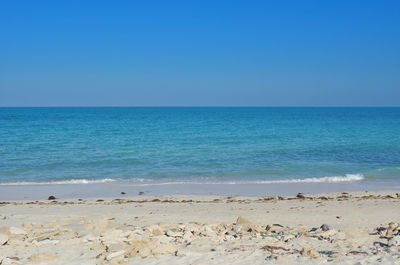 Scenic view of sea against clear blue sky