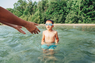 Full length of shirtless boy in swimming pool